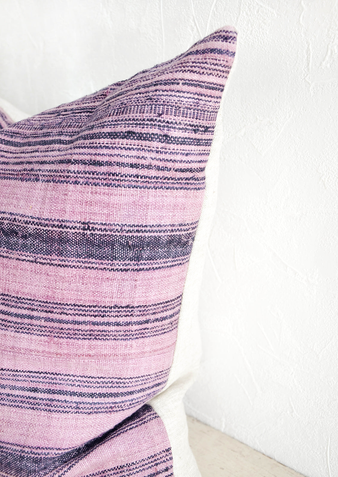Square pillow in striped vintage hemp fabric with natural linen backing