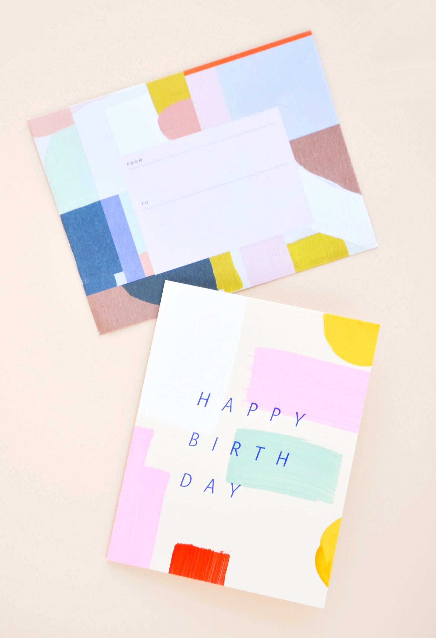Greeting card with hand-painted colorful brushstrokes and "Happy Birthday" printed in cobalt blue