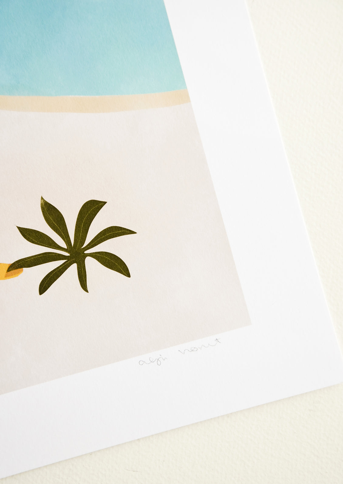 Artist's signature in pencil on corner of art print.