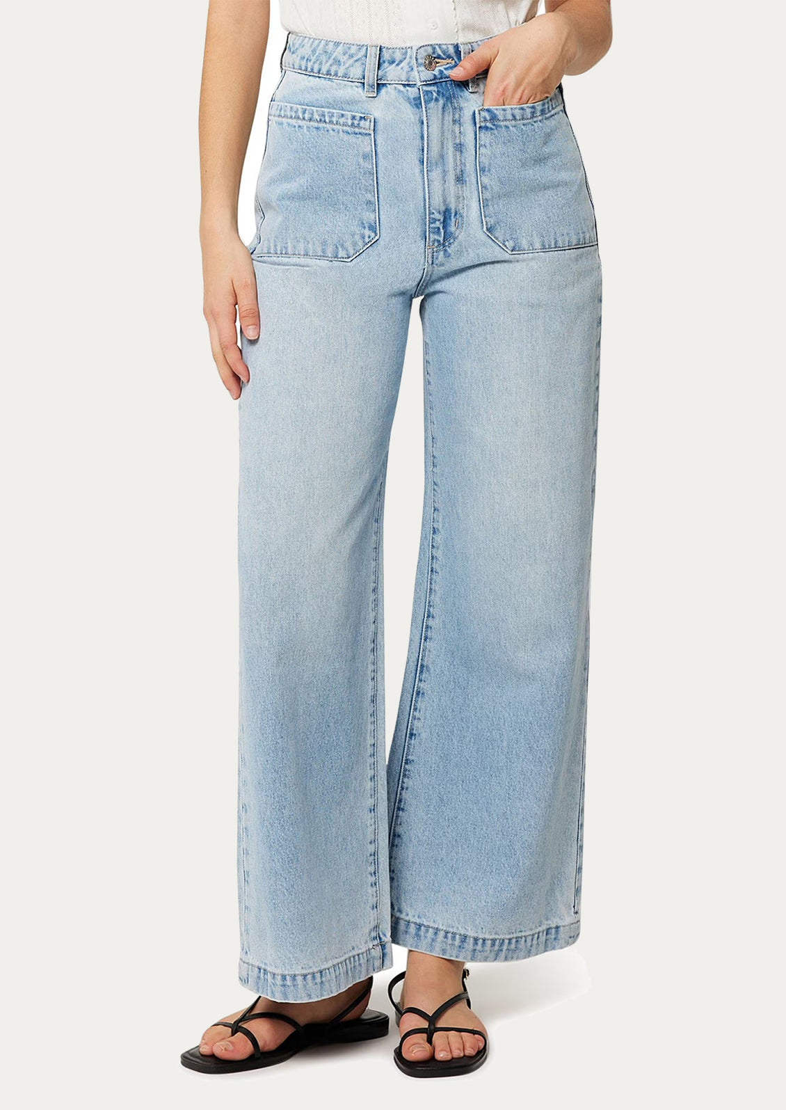 A person wearing a pair of light blue denim wide leg jeans with patch pockets at hips. 