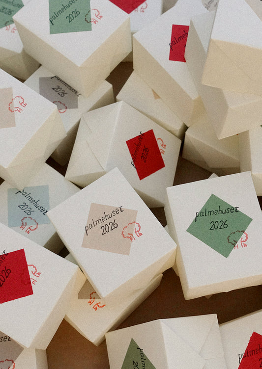 White boxes with red, green, and gray labels on a brown surface