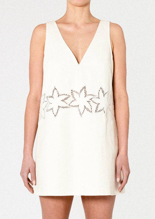 White sleeveless dress with floral embellishments on a white background