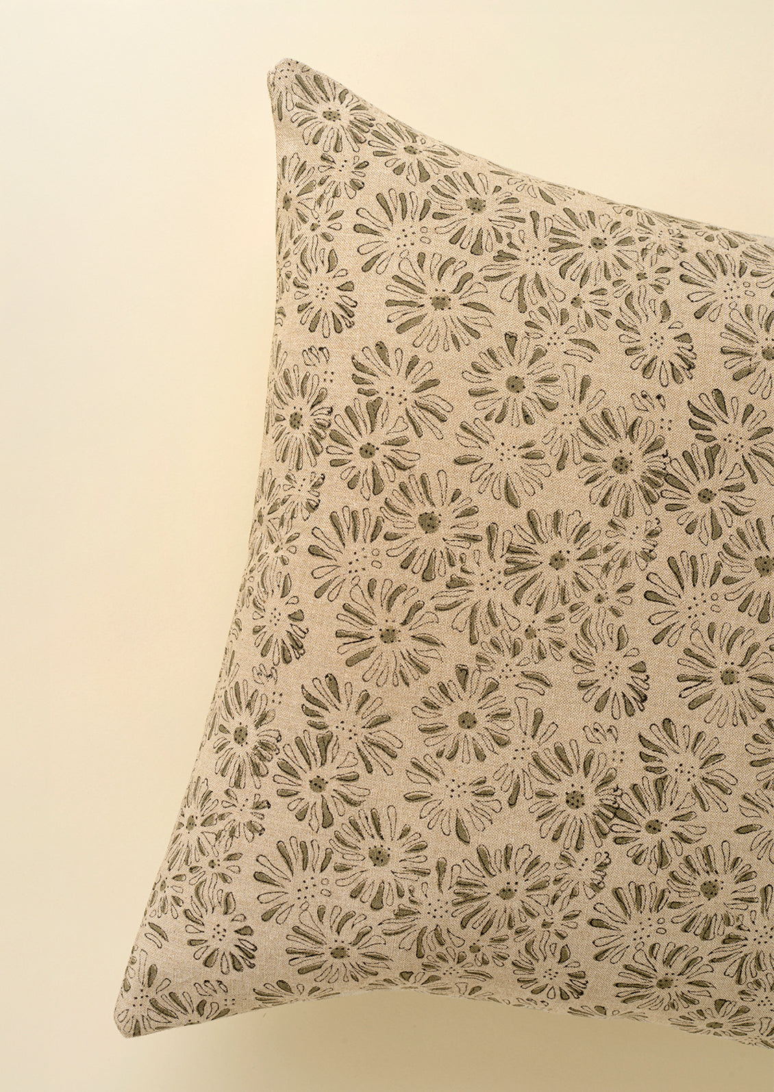 A square decorative throw pillow with a beige and brown floral lace-like pattern, shown against a plain cream background.