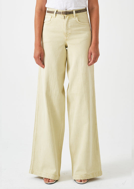 A person wearing a pair of long wide leg jeans in butter yellow color.