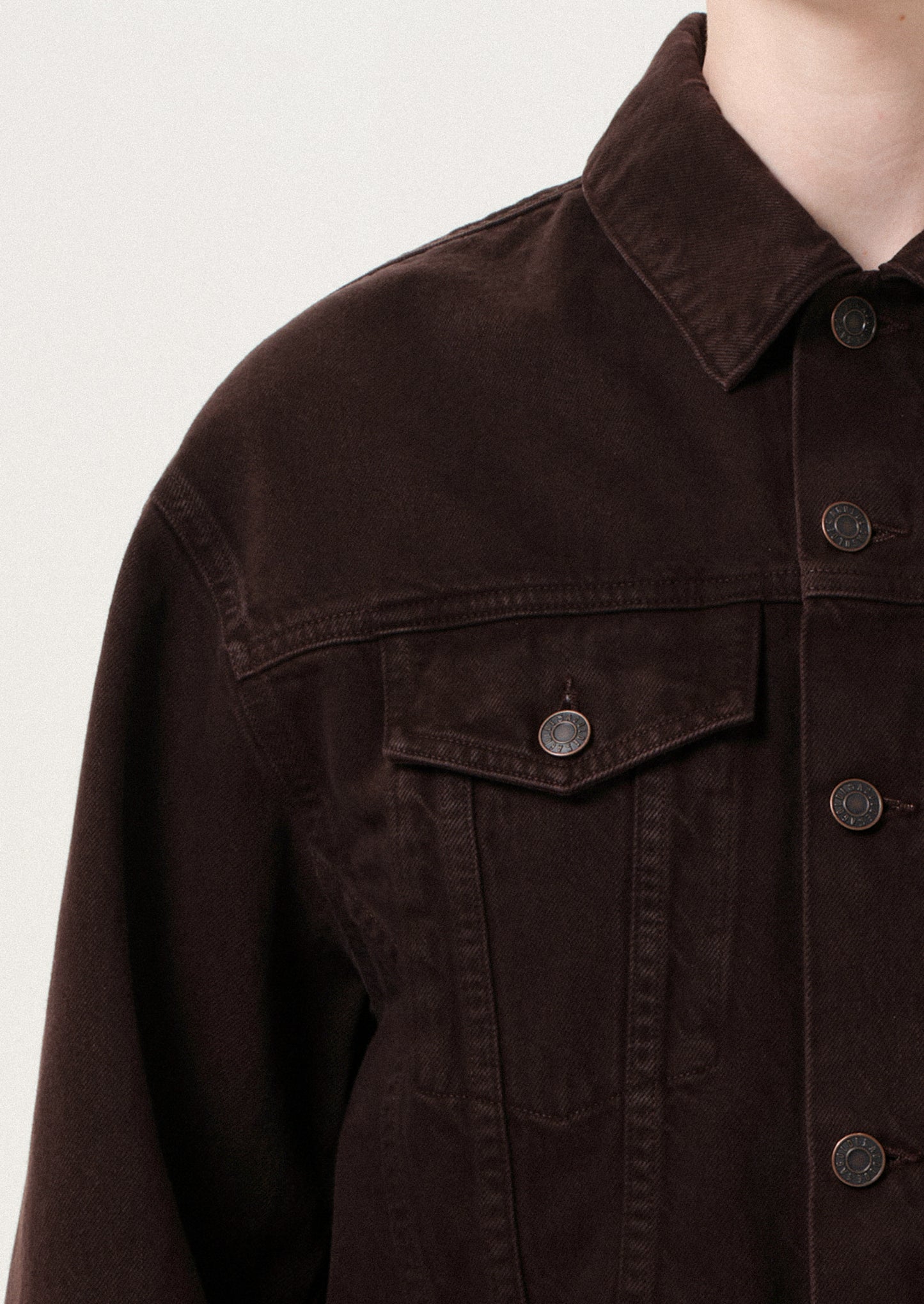 Brown jacket with button details on a light gray background