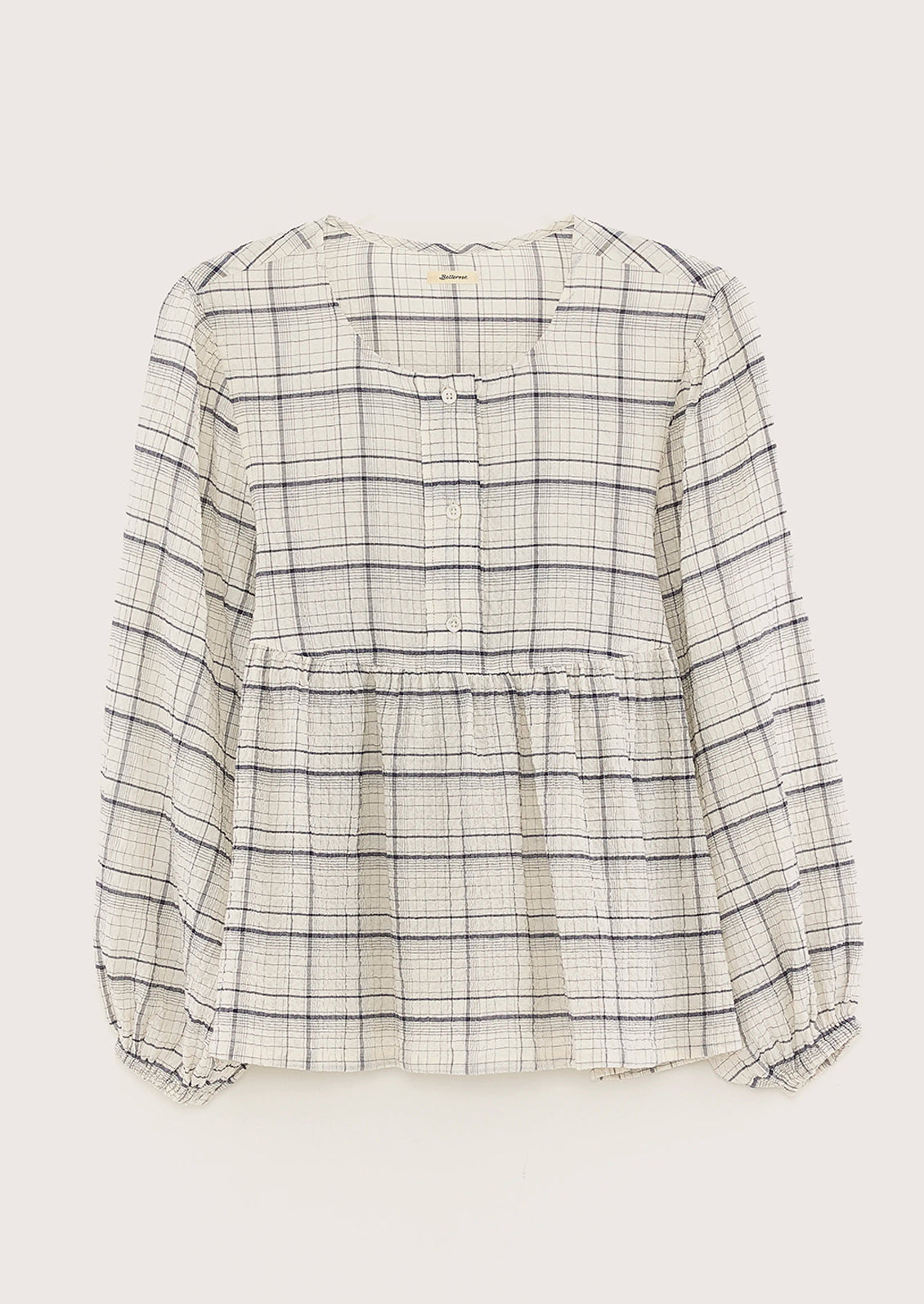 A crinkly textured blouse in ivory with navy check pattern.
