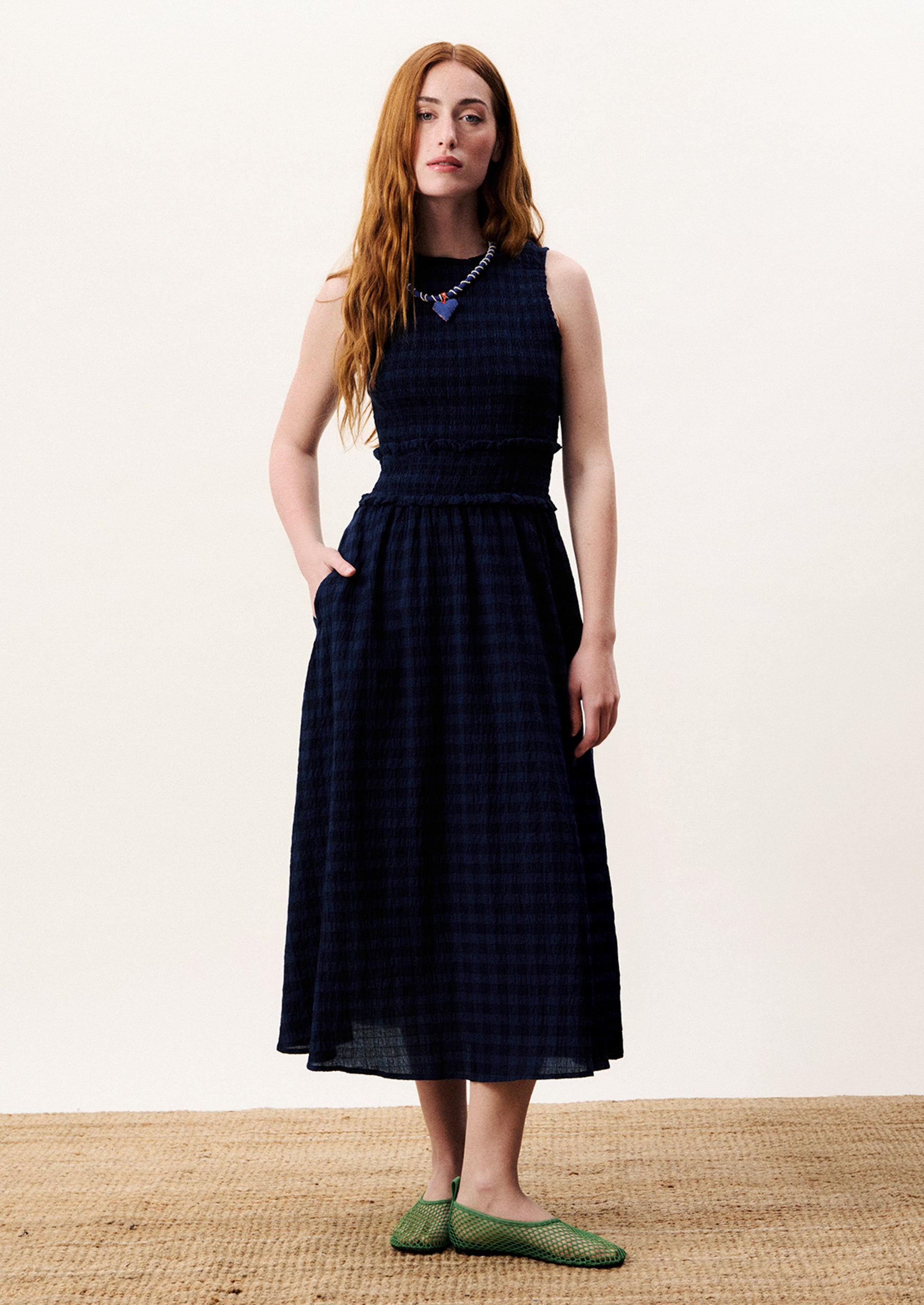 Woman wearing a checkered dress on a white background