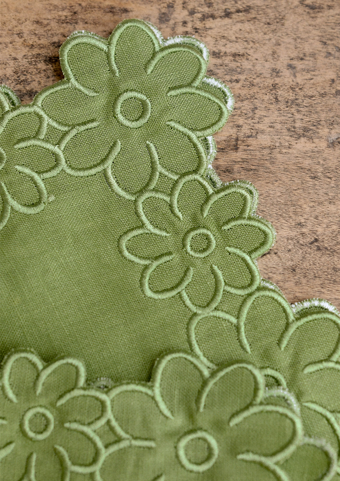 Green floral napkin on a wooden surface