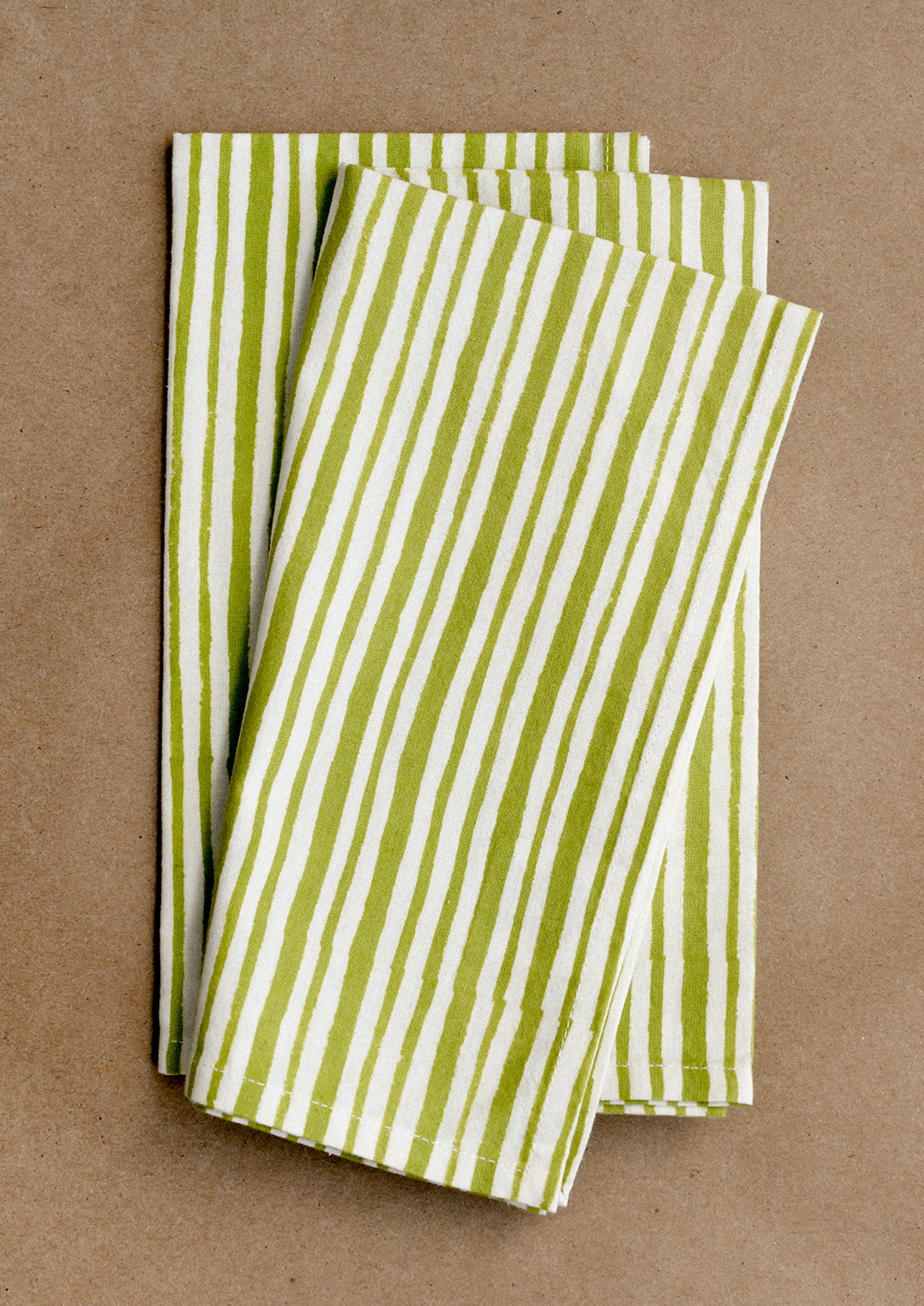Green and white striped napkins on a brown background