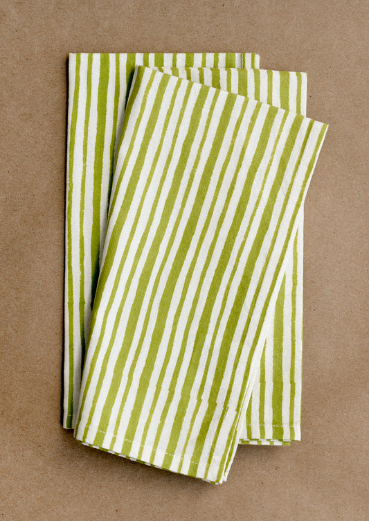 Green and white striped napkins on a brown background