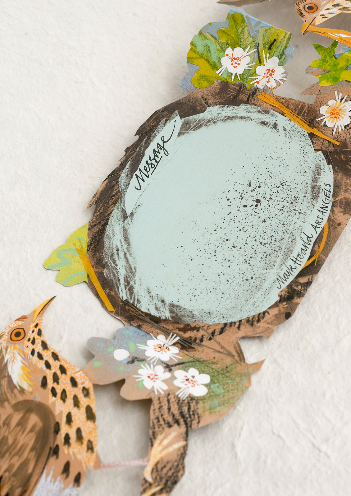 Decorative card with nature-themed elements on a textured surface