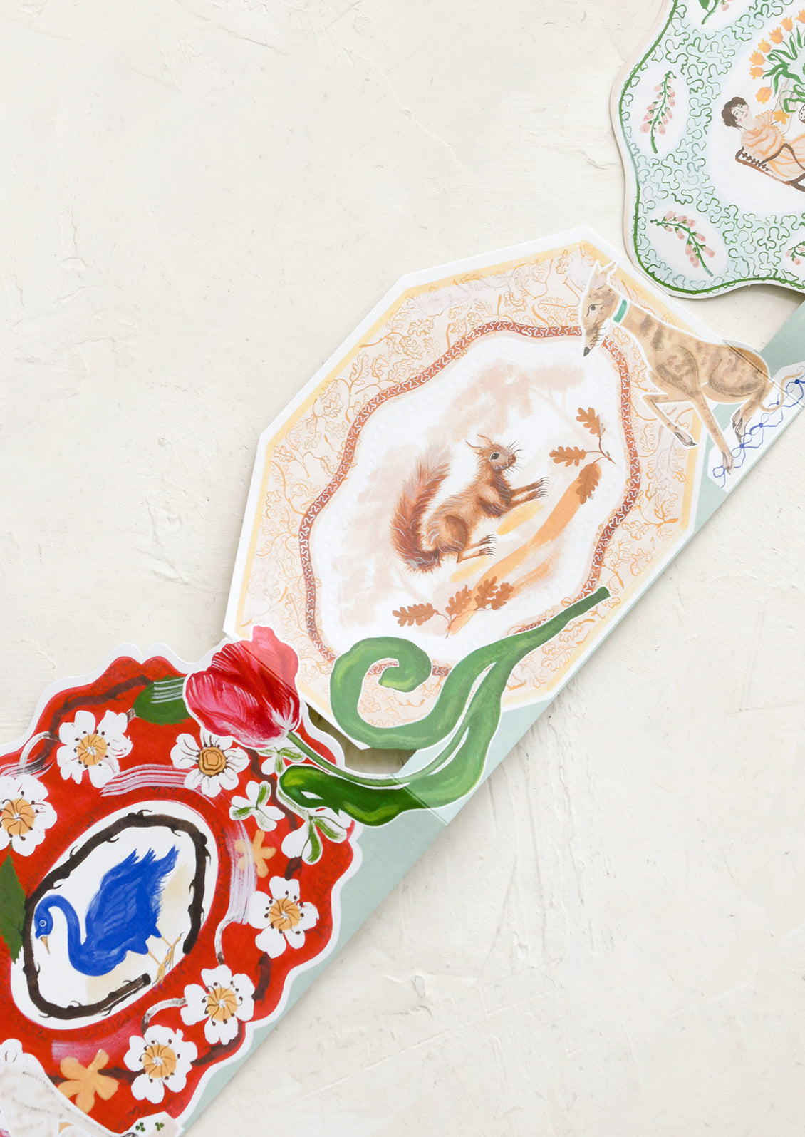 Decorative oyster shell with a painted design on a white surface