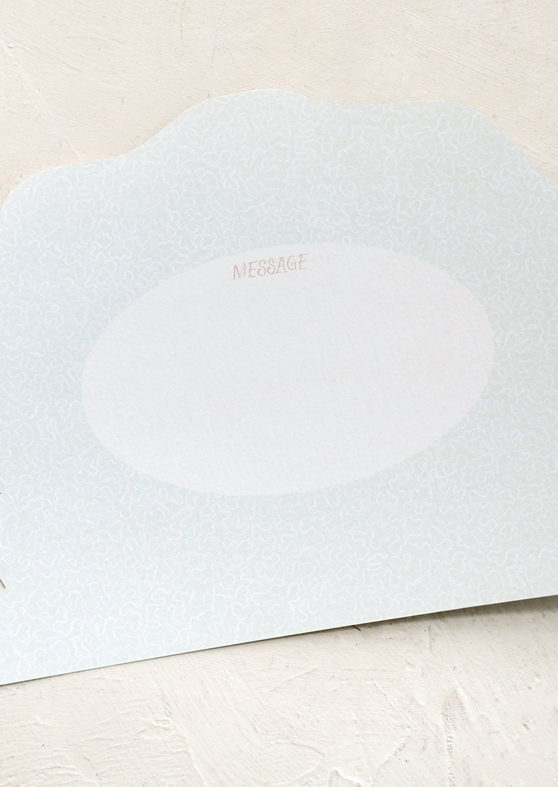 Light blue card with 'MESSAGE' area on a beige background
