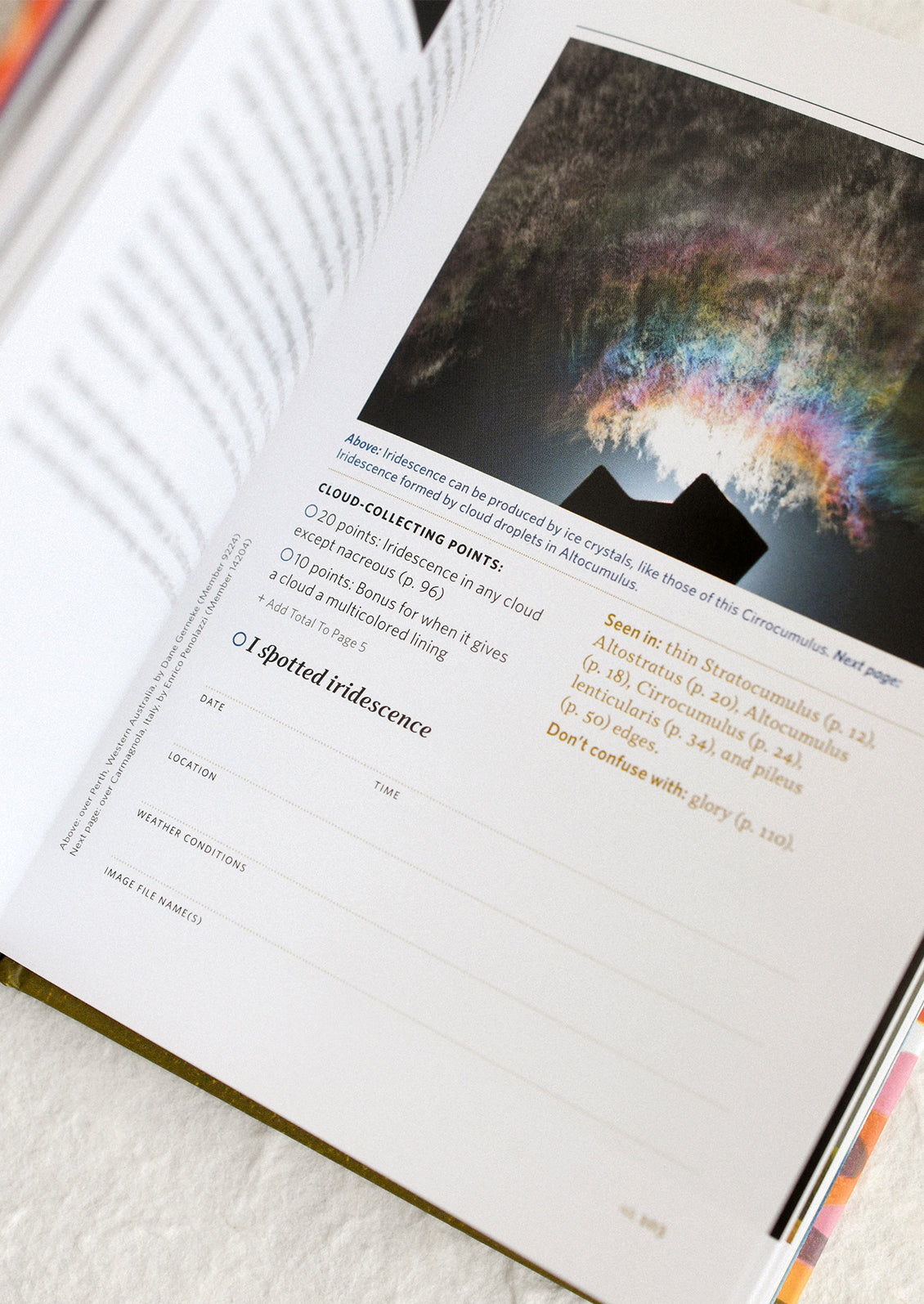 Open book with a colorful cloud illustration on a white surface