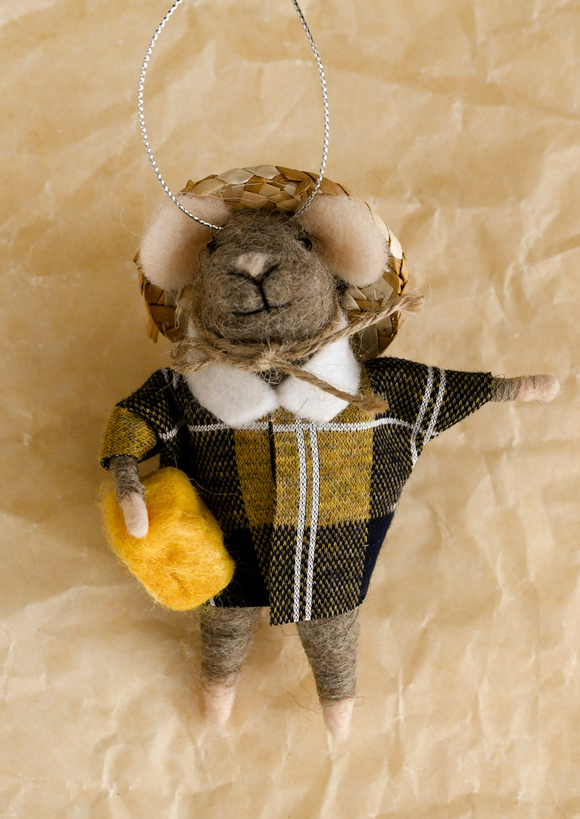 A mice felt ornament dressed as tourist of a cheese factory.