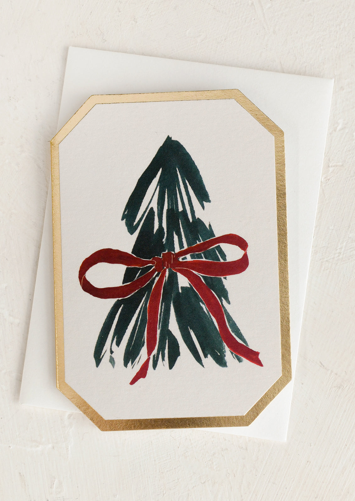 A mini die cut greeting card with tree illustration.