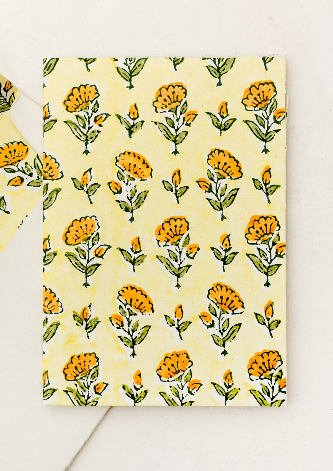 A block printed floral card with matching lined envelope in yellow colorway.