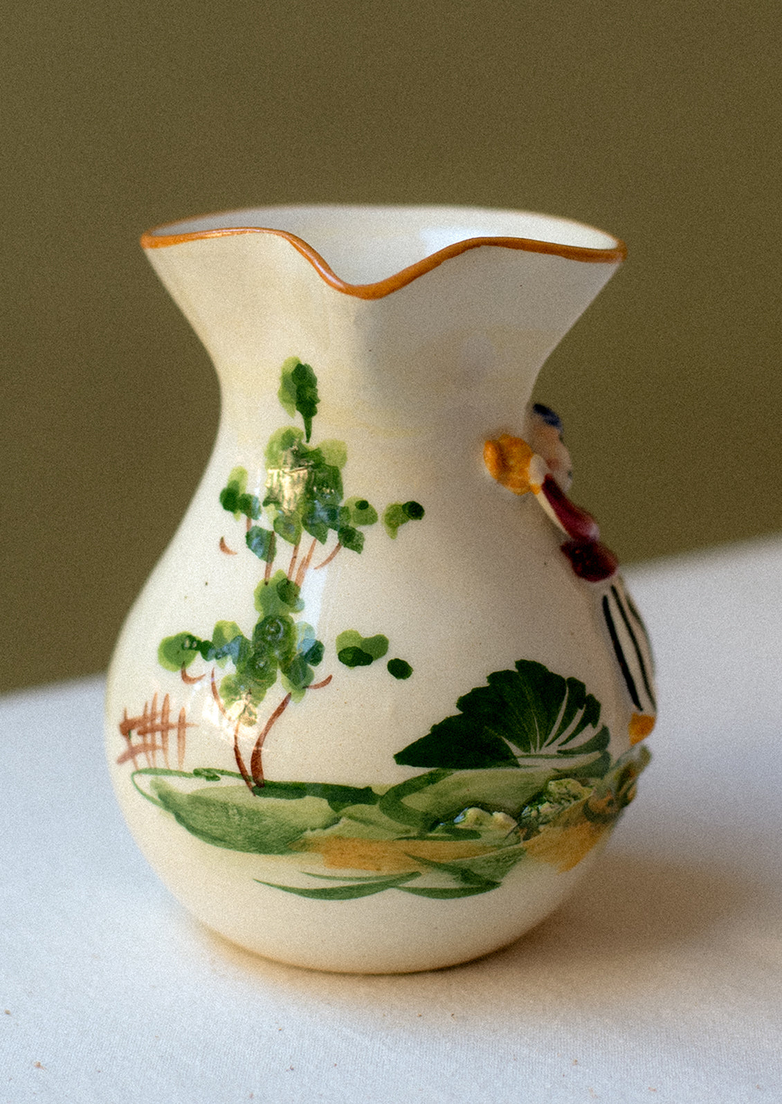Vintage hand-painted porcelain mini pitcher / creamer with three-dimensional relief detail.