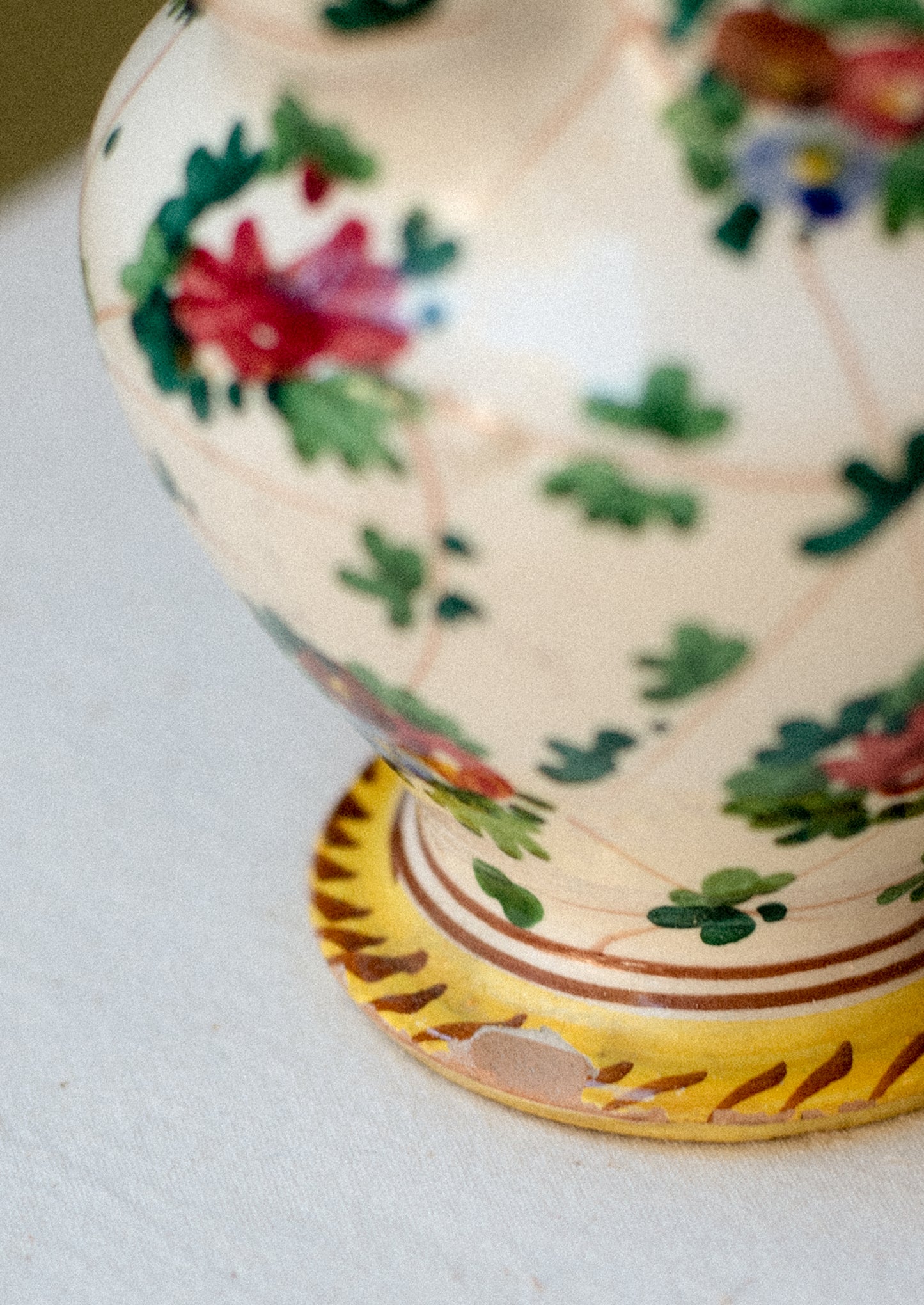 A painted porcelain pitcher with floral pattern.