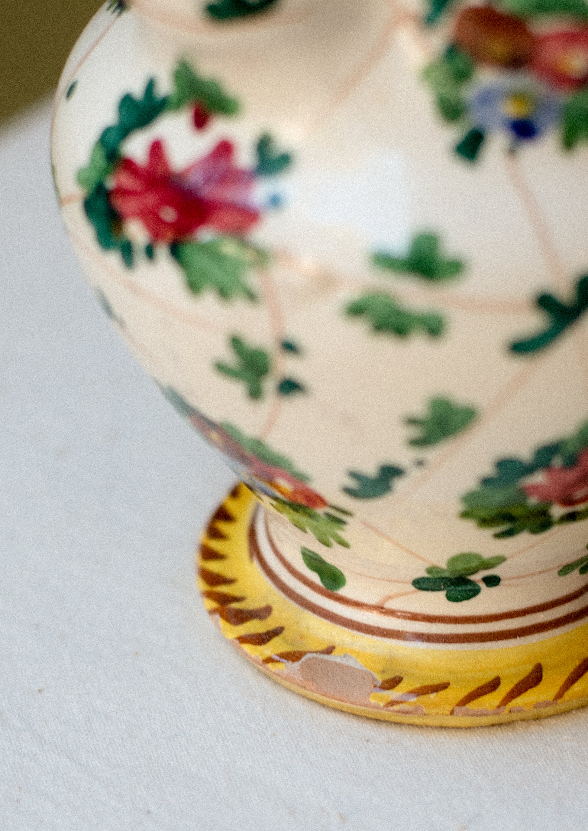 A painted porcelain pitcher with floral pattern.