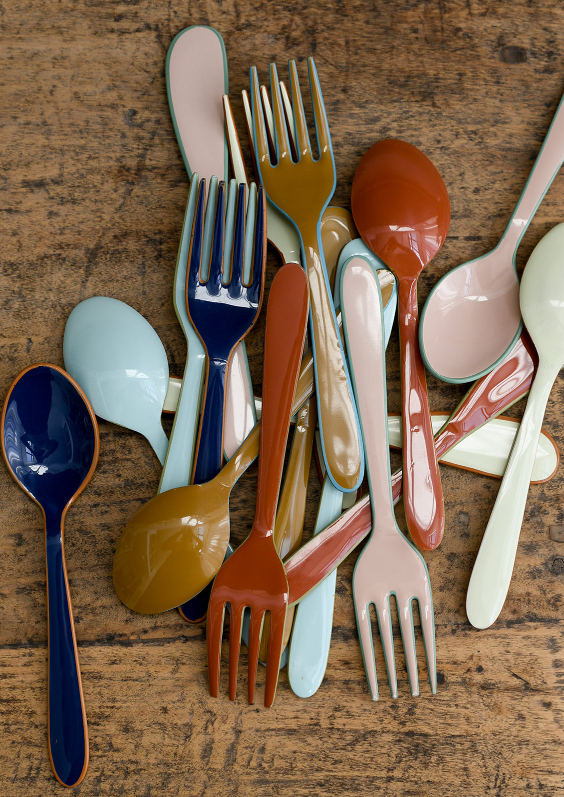 Colorful enamel spoon, fork and spreader knives in a fun mix of colors.