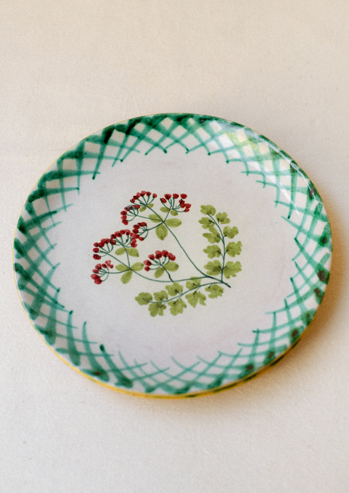 A pair of hand painted Italian plates with parsley flower detail.