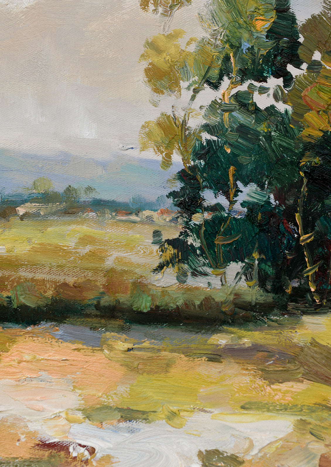 A framed original landscape oil painting of a meadow clearing with mountains and structures in the far distance.