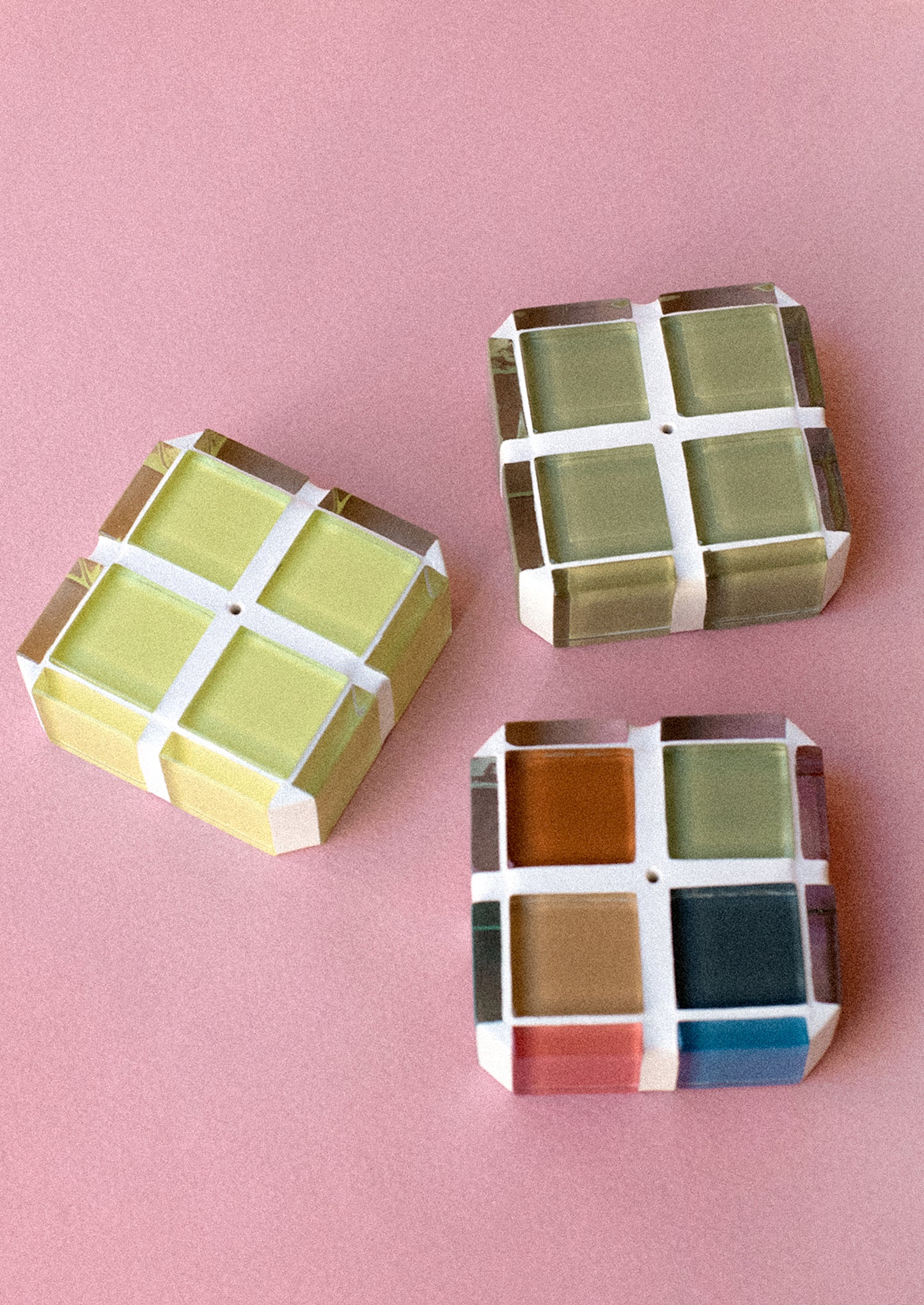 Square cube shape incense holder made up of glass tiles in different color options.