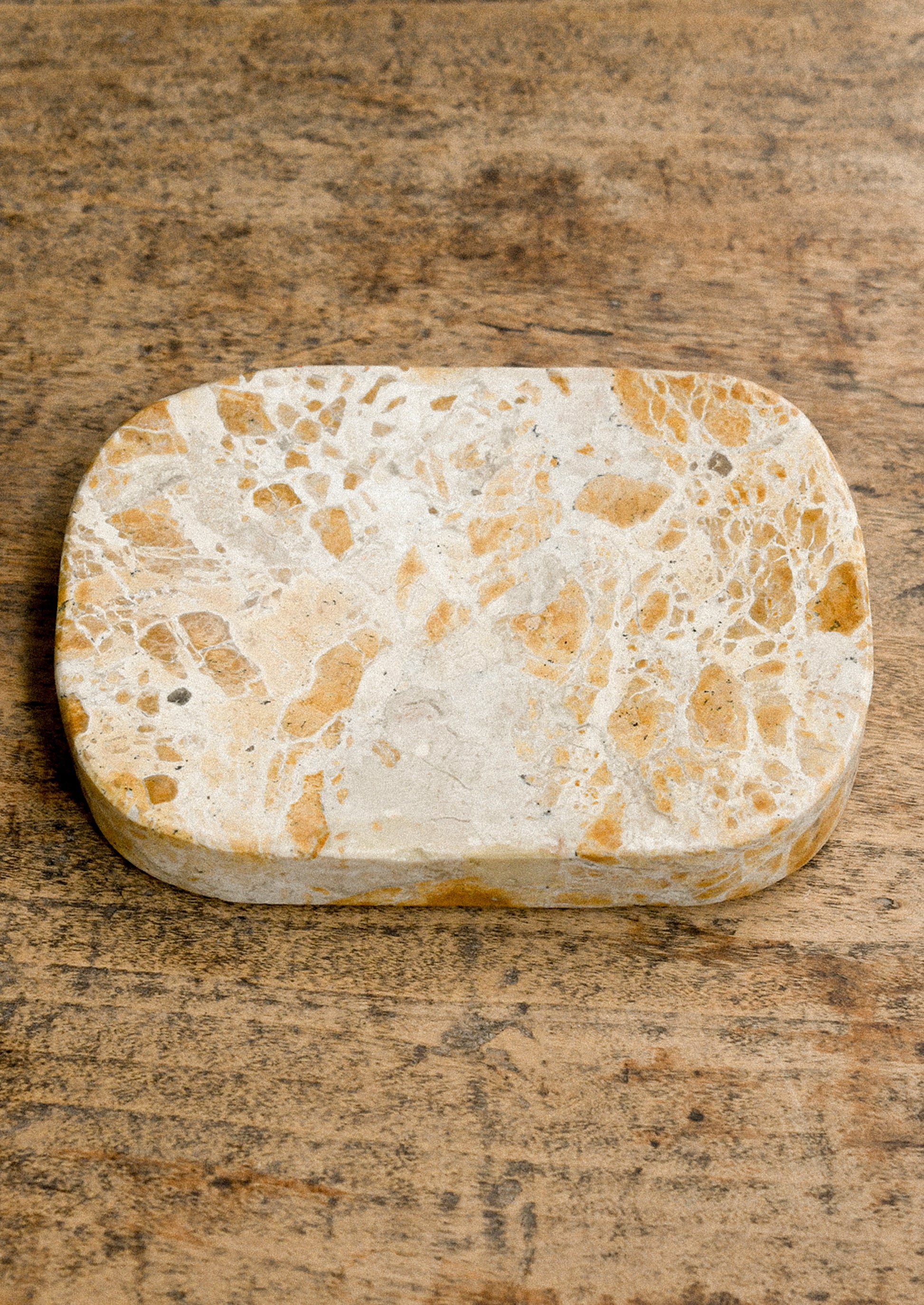 A tan marble soap dish.