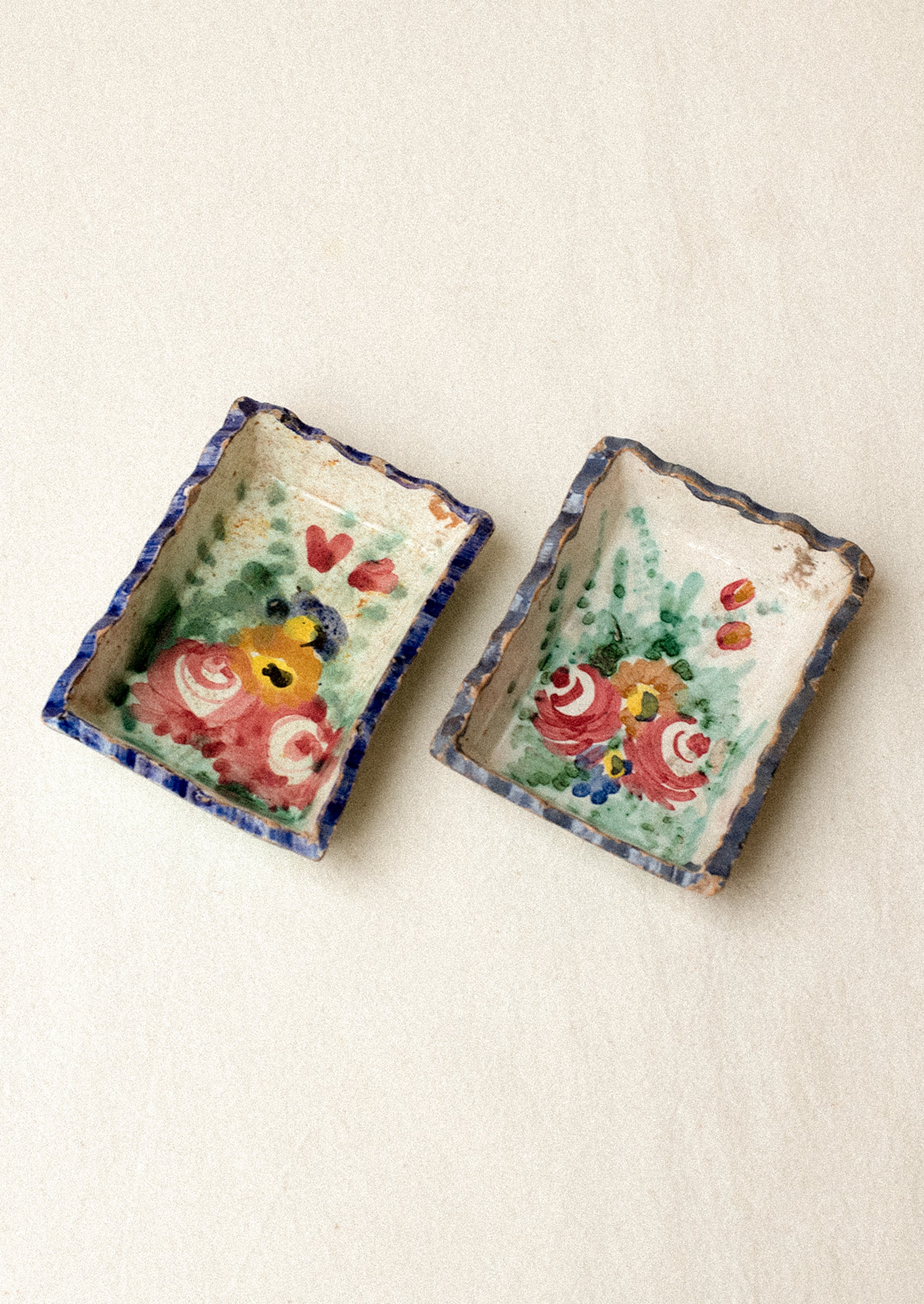 Two small rectangular ceramic trays with floral designs.