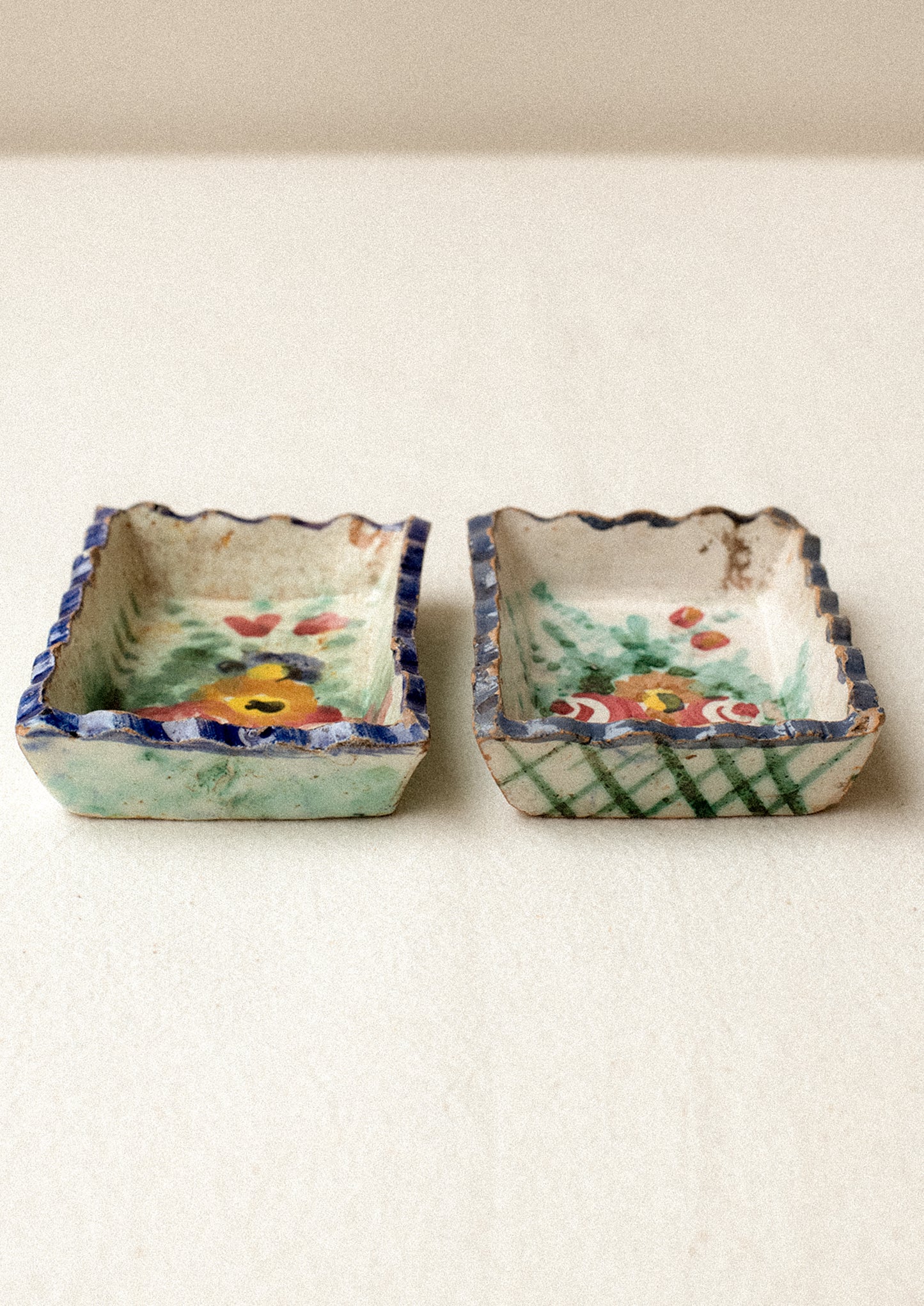 Two small rectangular ceramic trays with floral designs.