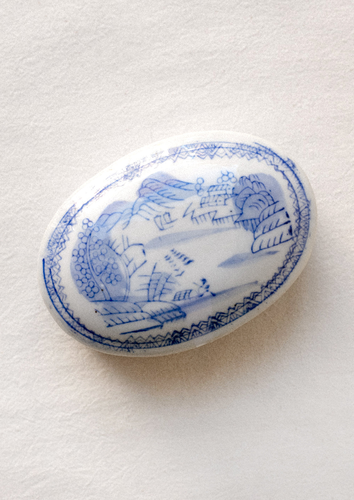 A blue and white chinoiserie patterned lidded ceramic box.