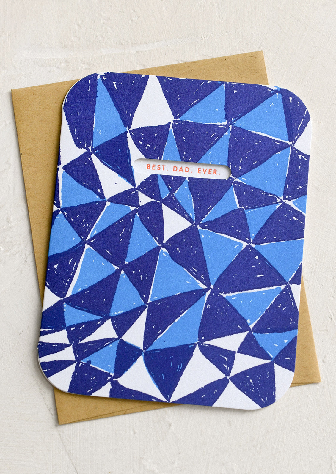 A blue triangle print card with cutout window revealing red lettering reading "Best. Dad. Ever.".