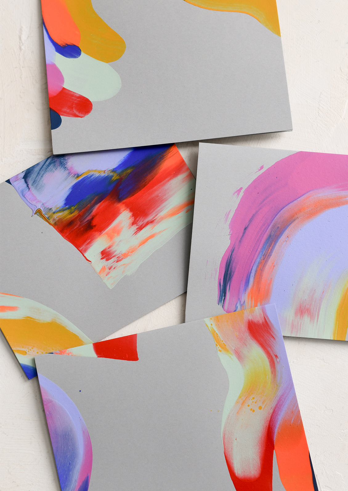 A set of grey greeting cards with brightly hand painted abstract pattern.