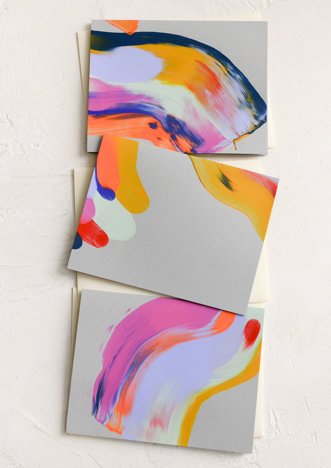 A set of grey greeting cards with brightly hand painted abstract pattern.