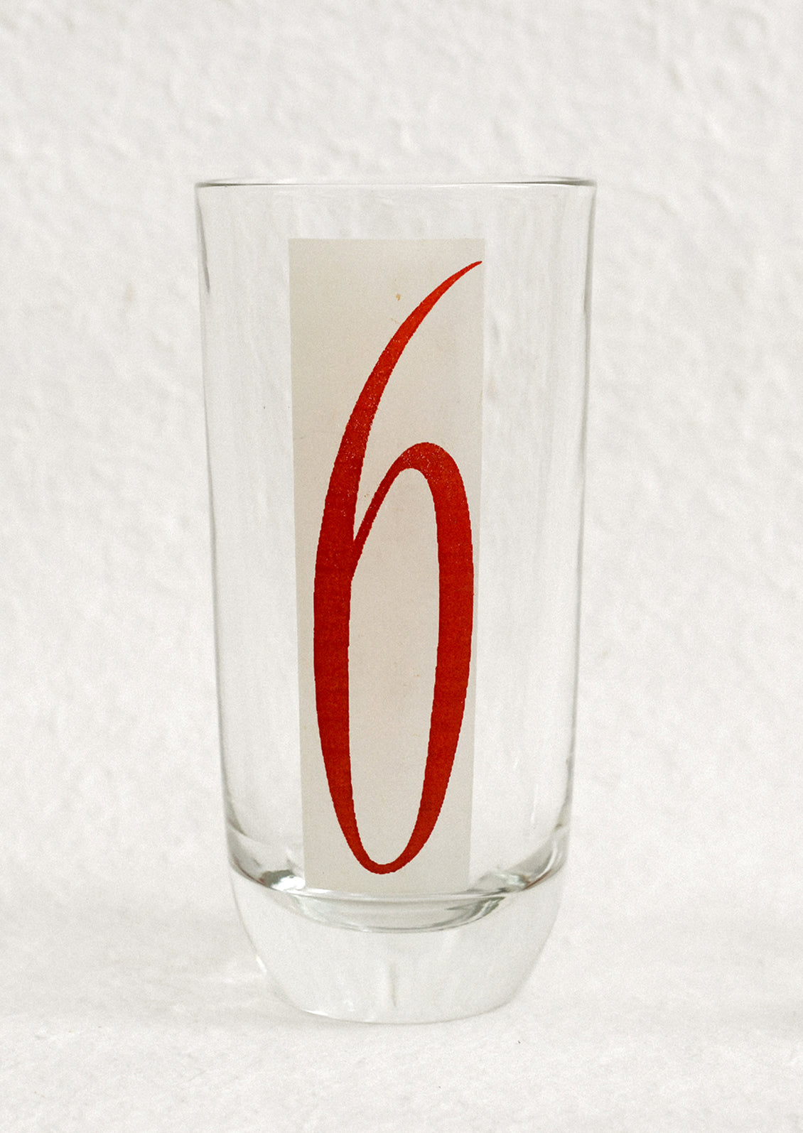 A set of high ball glasses with frosted red and white digit decal on each glass, numbering 1 through 6.