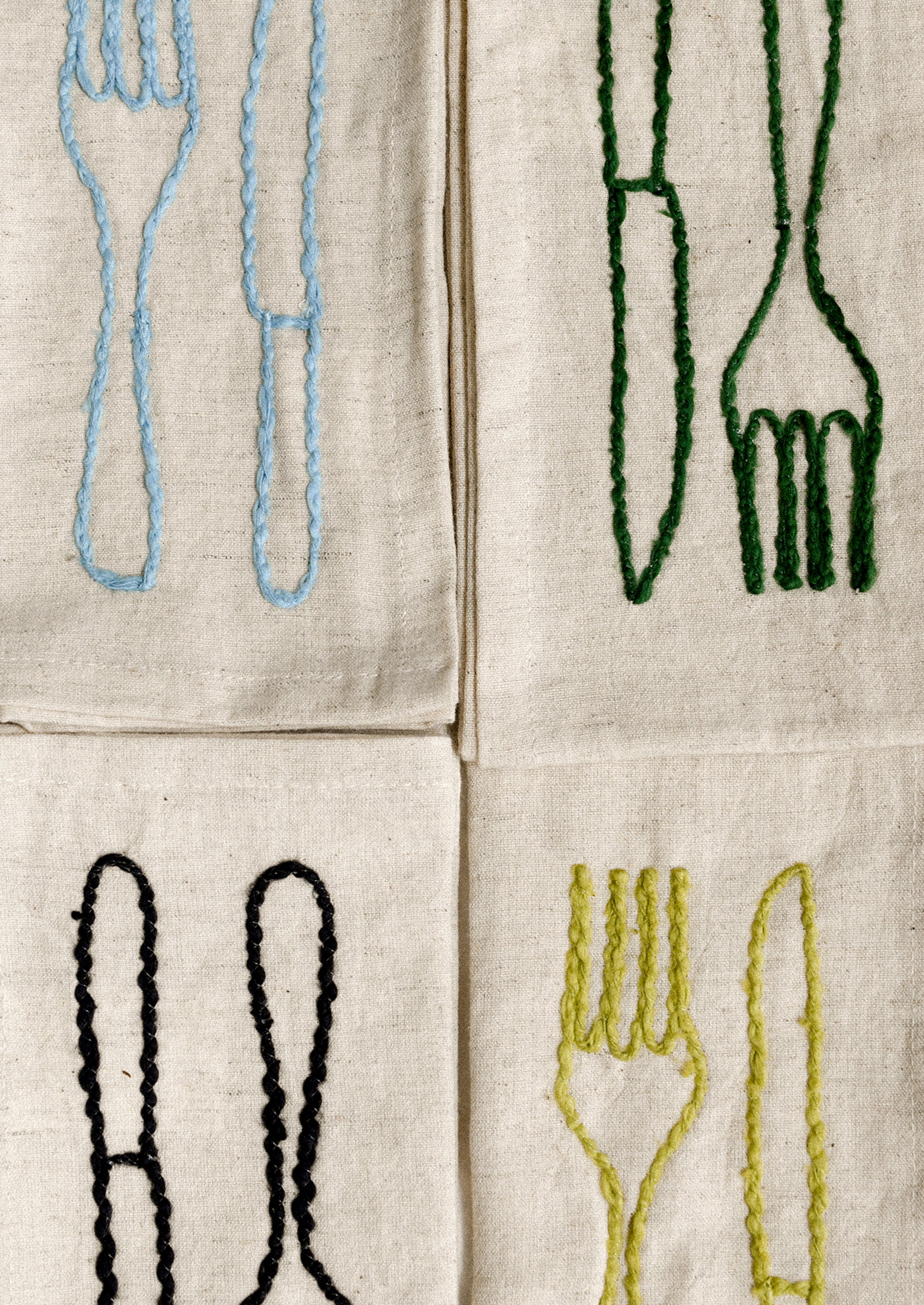 A set of natural linen napkins with embroidered fork and knife motif in assorted colors.