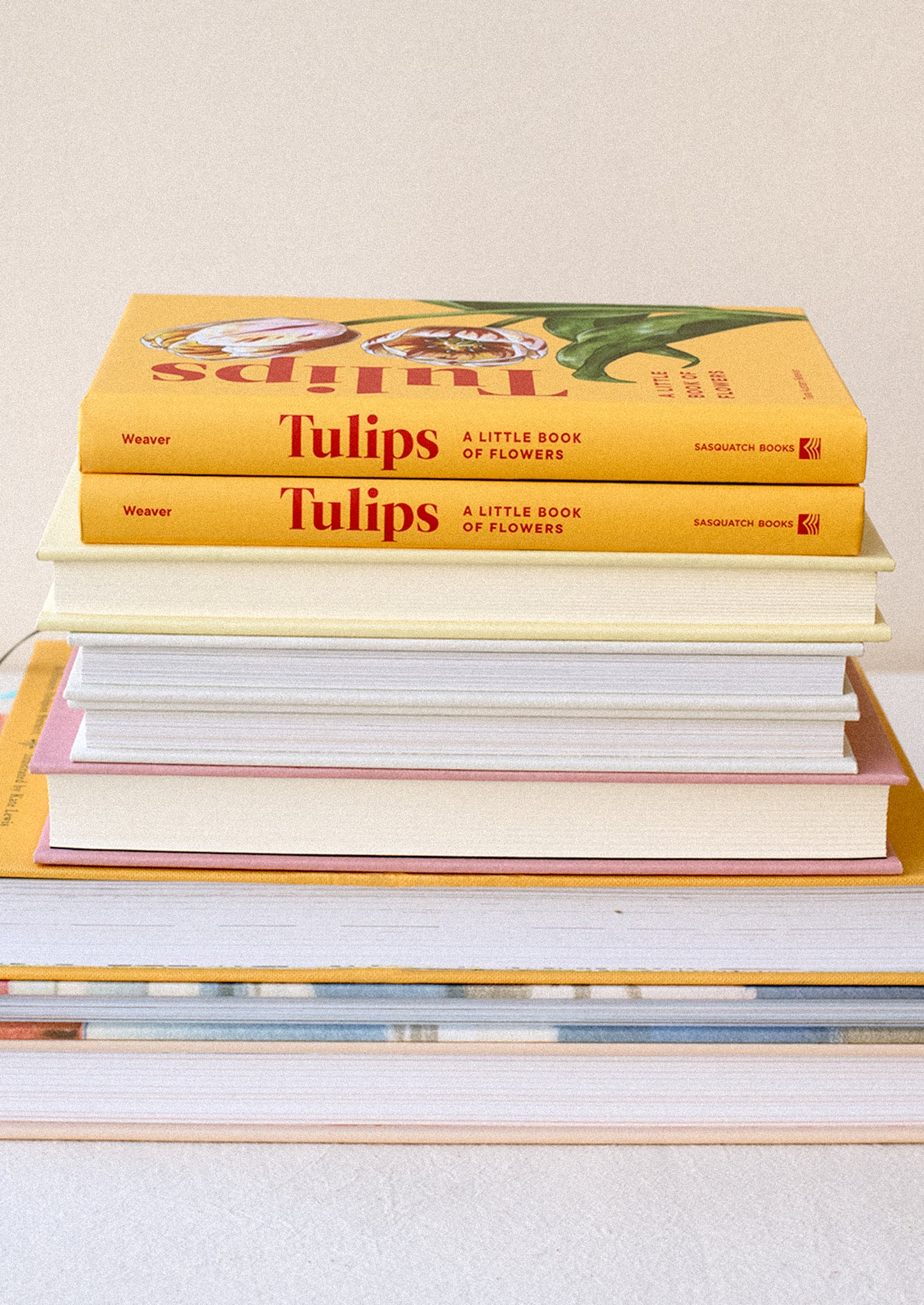 A small hardcover book in yellow titled "Tulips".