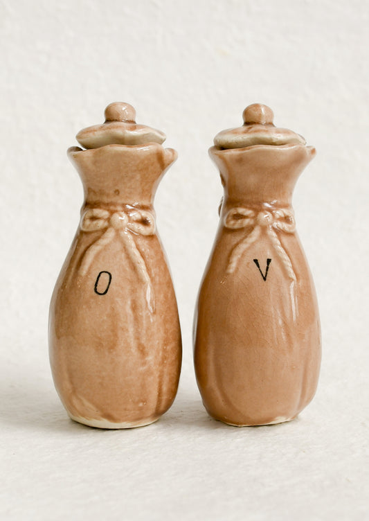 A pair of ceramic oil & vinegar cruets in the shape of bushel baskets.