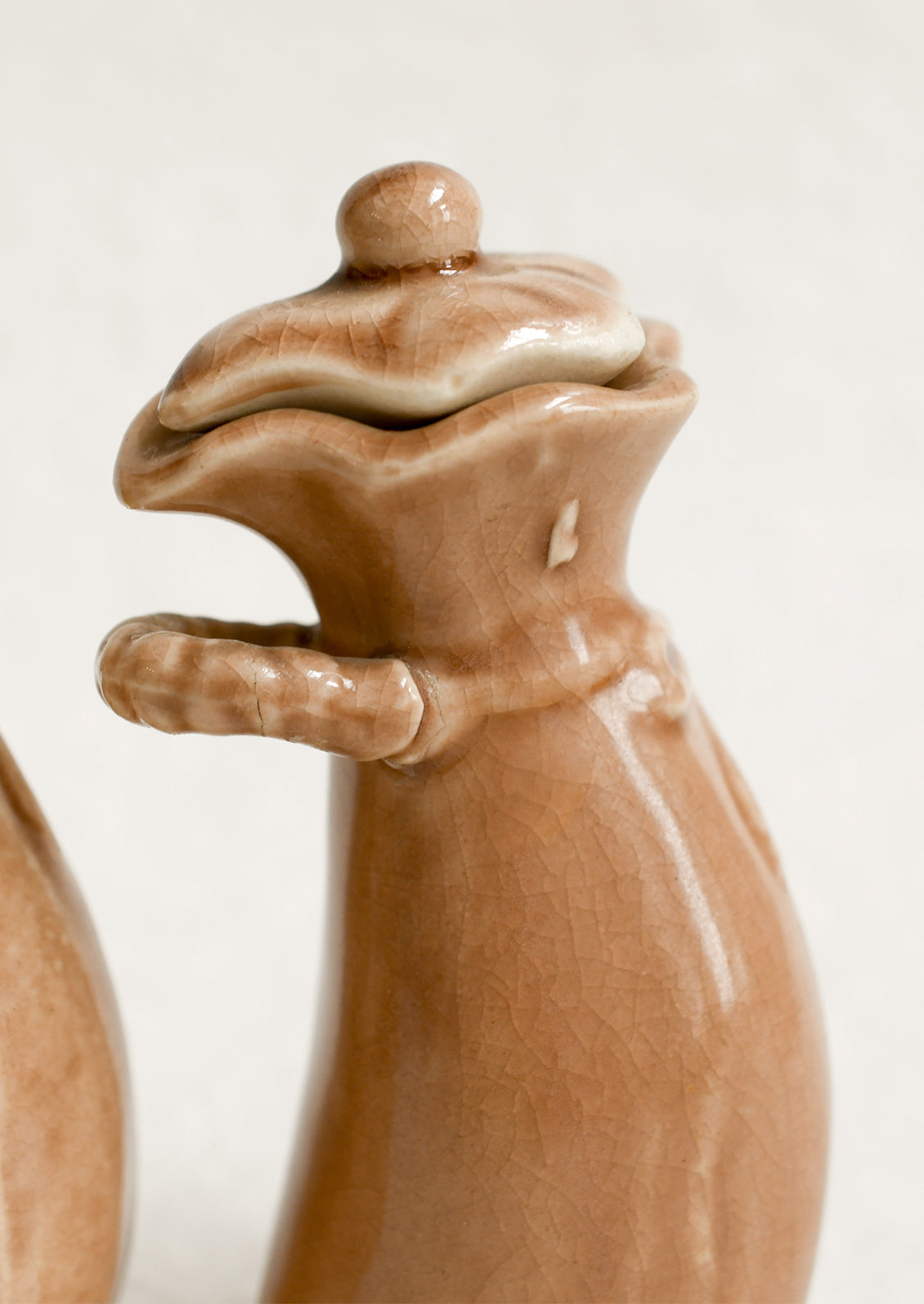 A pair of ceramic oil & vinegar cruets in the shape of bushel baskets.