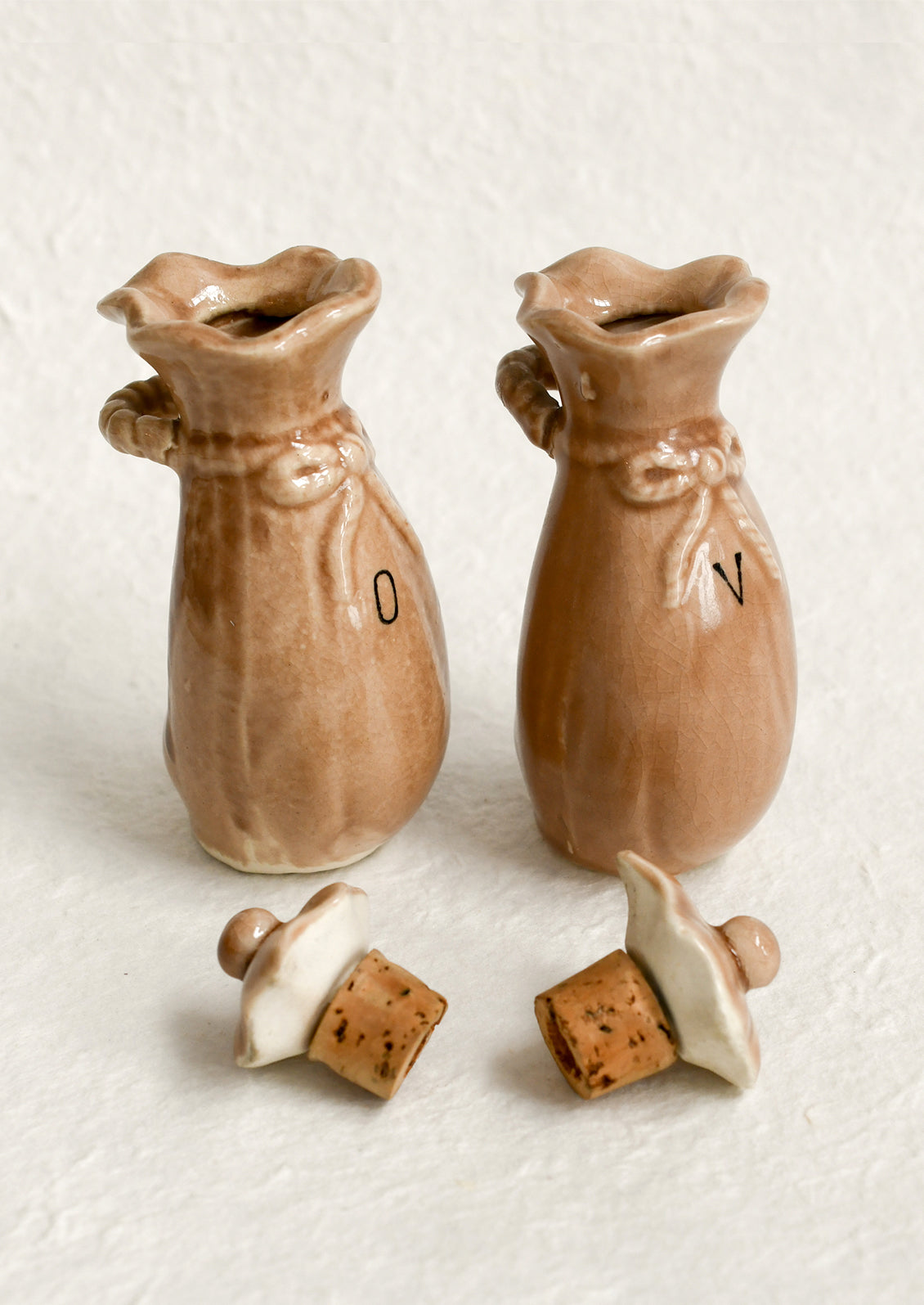 A pair of ceramic oil & vinegar cruets in the shape of bushel baskets.