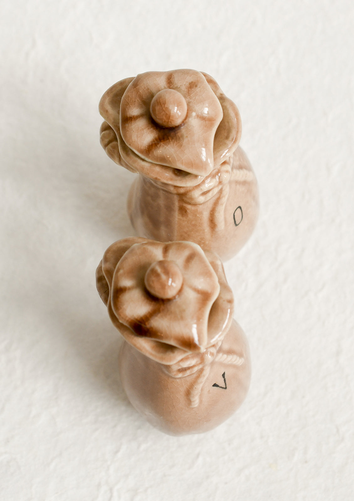 A pair of ceramic oil & vinegar cruets in the shape of bushel baskets.