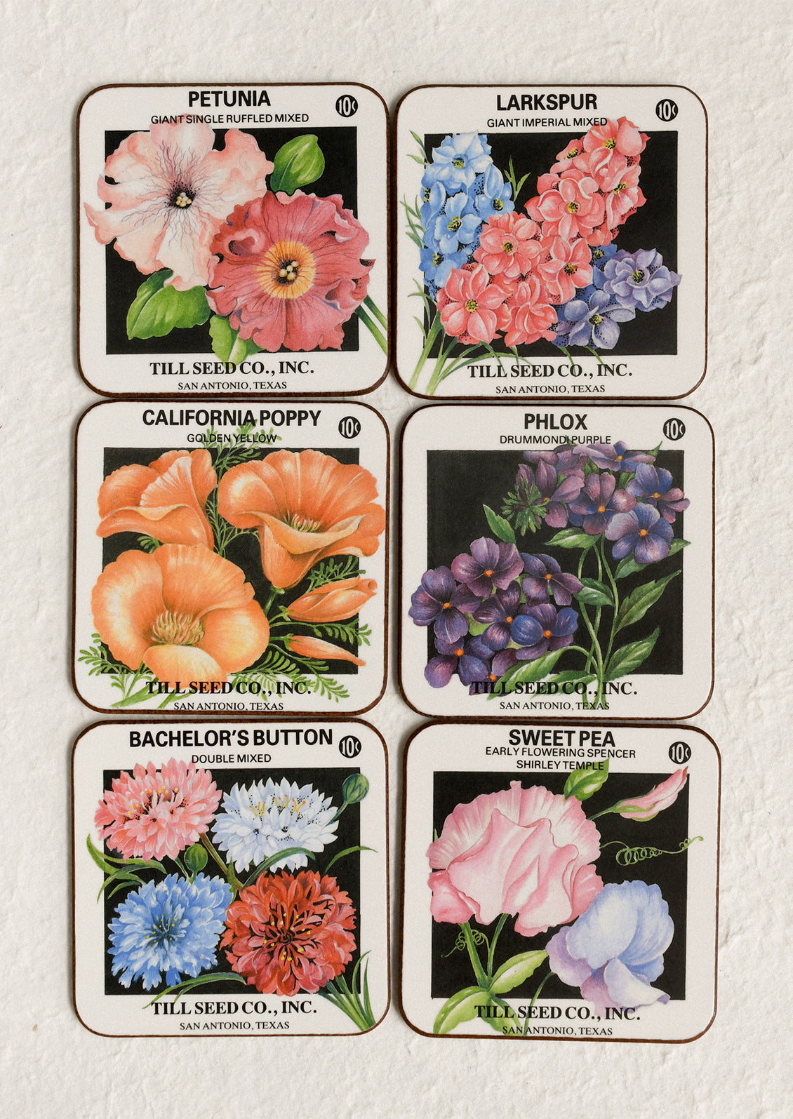 Set of seed packets with floral illustrations on a textured surface