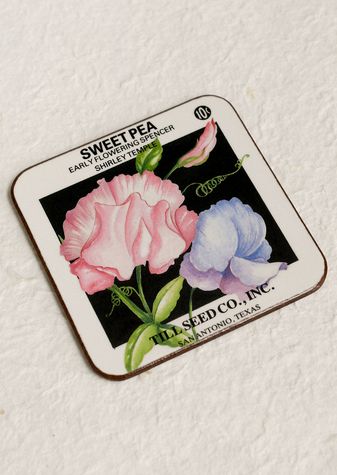 Vintage seed packet with sweet pea flowers on a textured white background