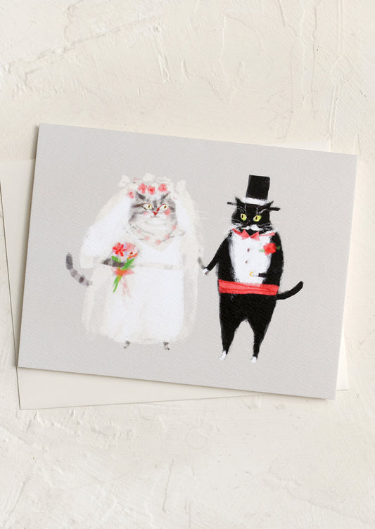 Card with illustration of cats in wedding attire on a white background.