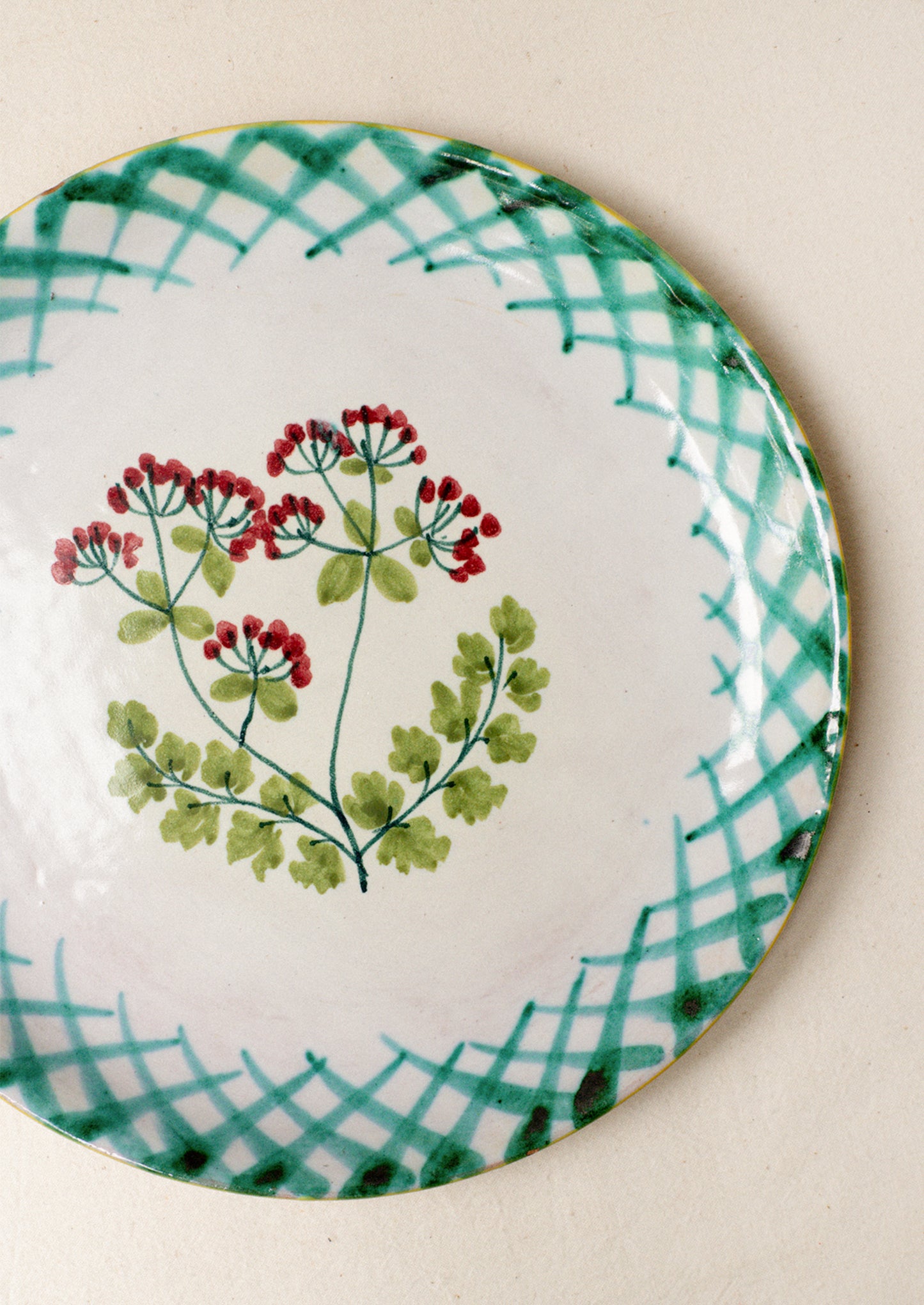 A pair of hand painted Italian plates with parsley flower detail.