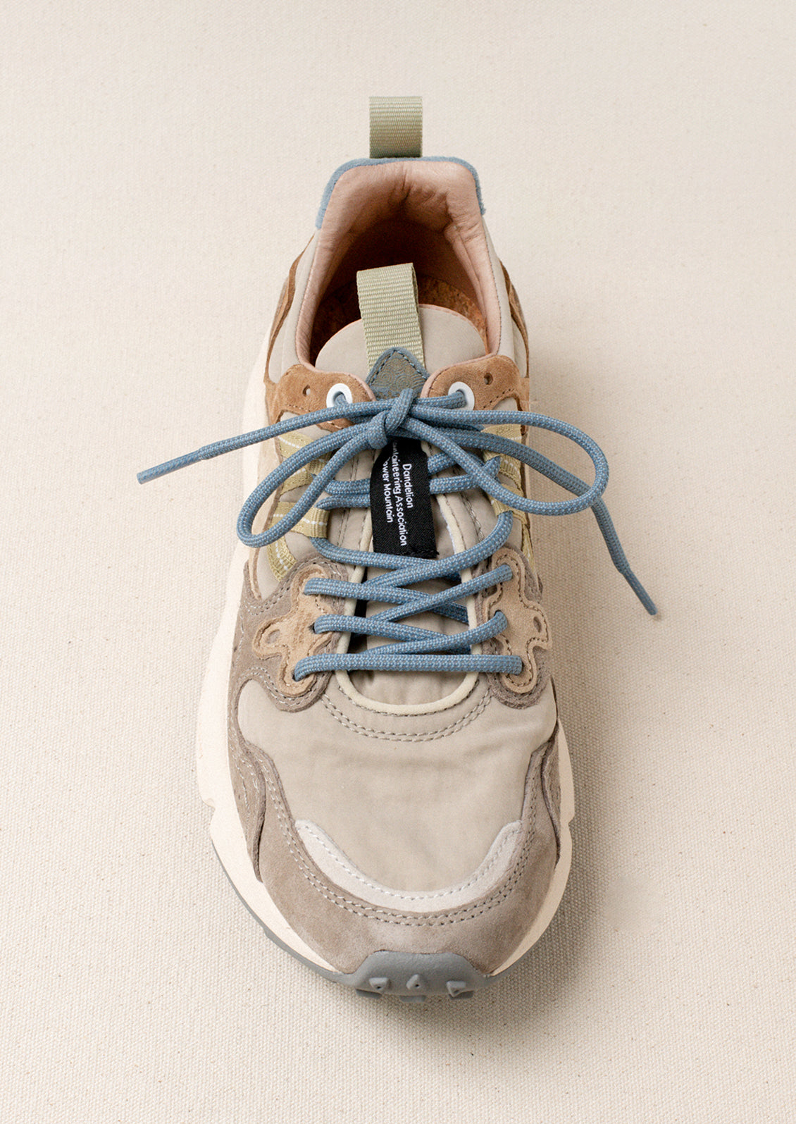 A pair of sporty sneakers in taupe/pastel multi color combo.