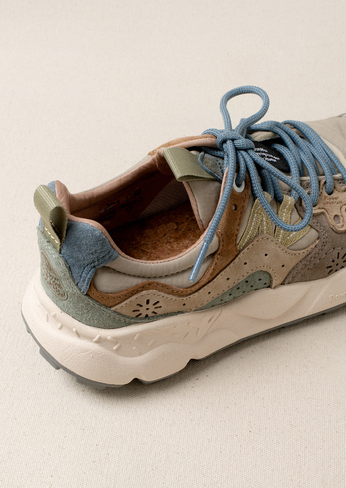 A pair of sporty sneakers in taupe/pastel multi color combo.