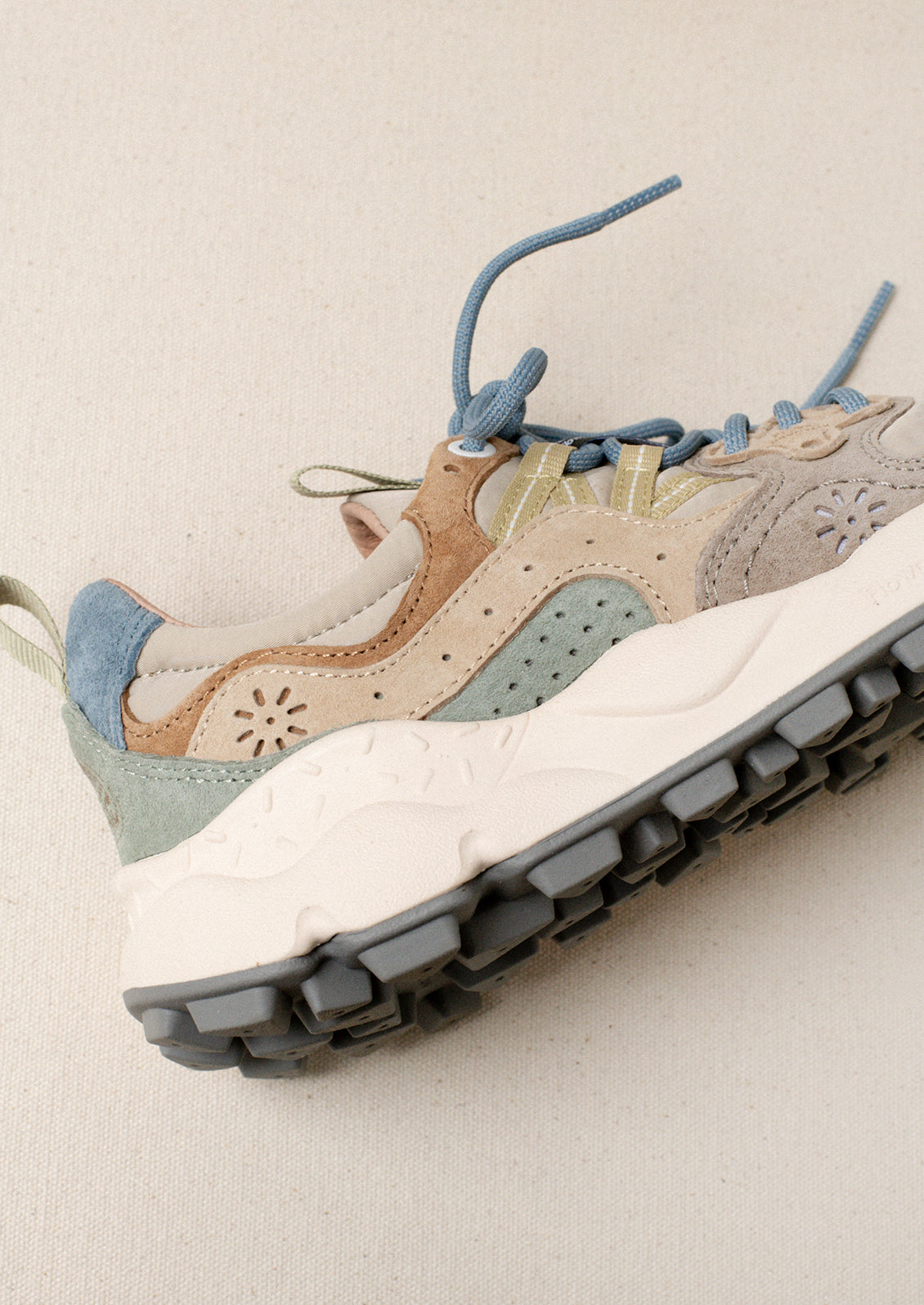 A pair of sporty sneakers in taupe/pastel multi color combo.