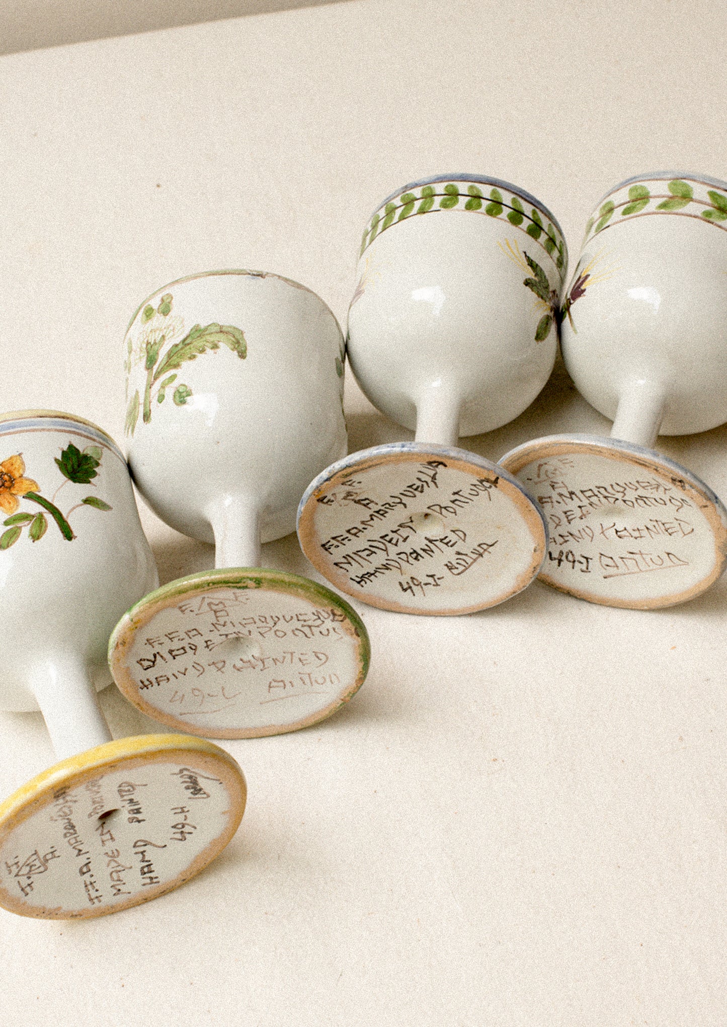 A set of four floral painted wine glasses.